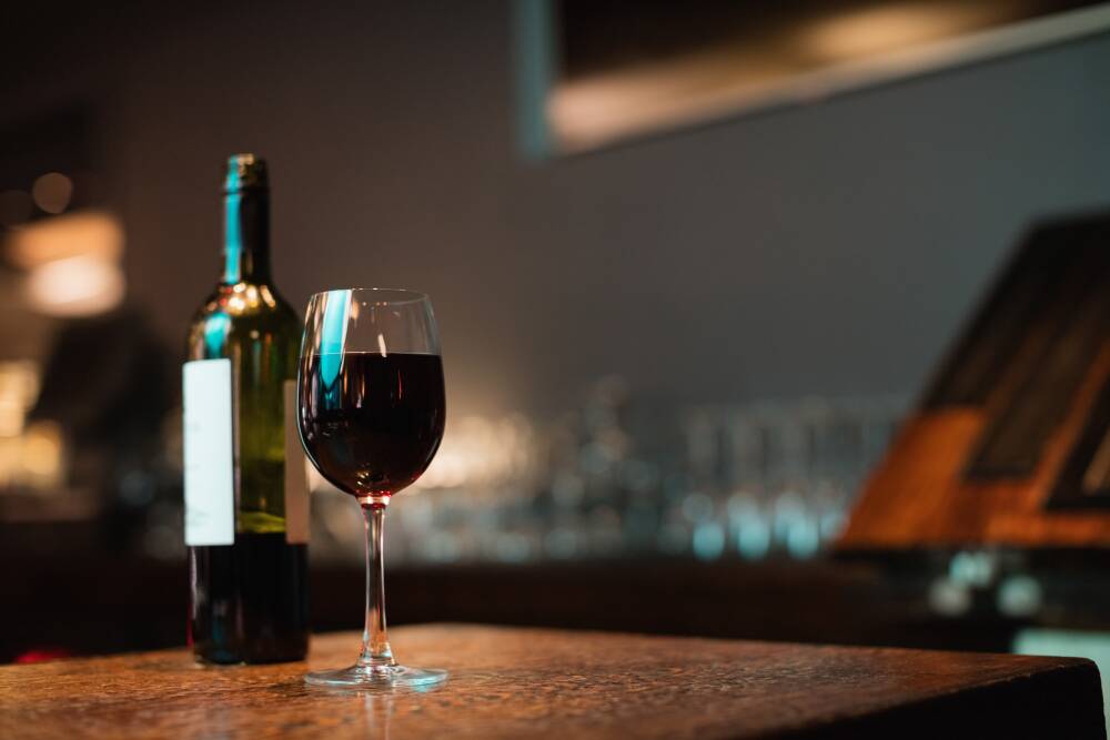 glass-red-wine-bottle-bar-counter.jpg